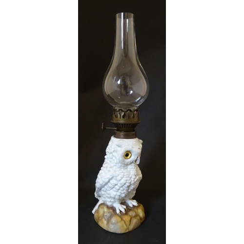 1697 - A novelty oil lamp the ceramic base formed as an owl with glass eyes. Marked under. Approx. 14 1/2