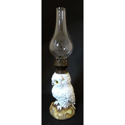 1697 - A novelty oil lamp the ceramic base formed as an owl with glass eyes. Marked under. Approx. 14 1/2