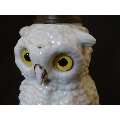 1697 - A novelty oil lamp the ceramic base formed as an owl with glass eyes. Marked under. Approx. 14 1/2