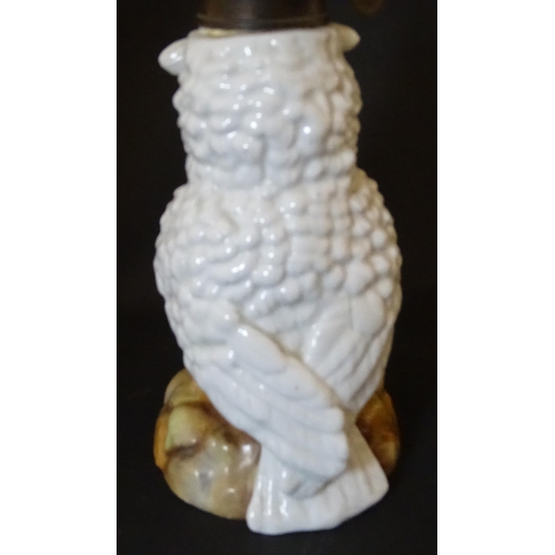 1697 - A novelty oil lamp the ceramic base formed as an owl with glass eyes. Marked under. Approx. 14 1/2