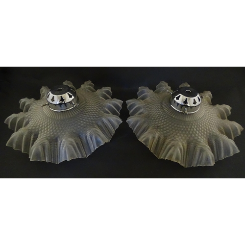 1702 - A pair of frosted glass light shades with frilled and lattice detail and chrome mounts. Approx. 11