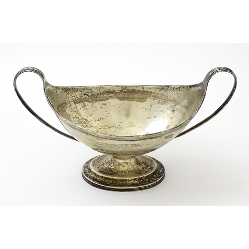 621 - A silver twin handled pedestal boat shaped dish, hallmarked London 1905 maker C S Harris & Sons Ltd.... 