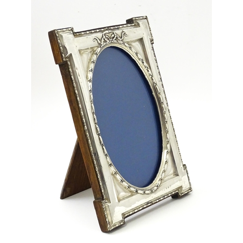 648 - An easel back photograph frame with silver surround hallmarked Birmingham 1914, maker W. I Broadway ... 