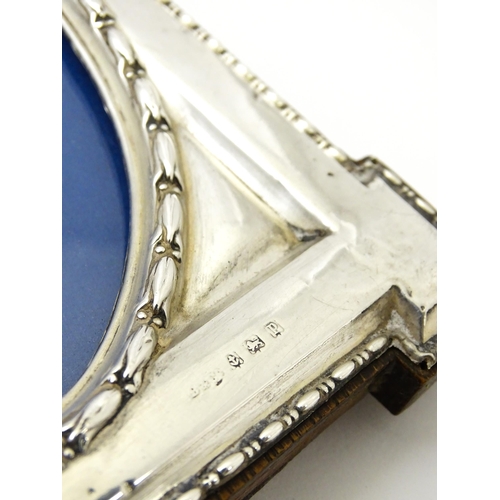 648 - An easel back photograph frame with silver surround hallmarked Birmingham 1914, maker W. I Broadway ... 