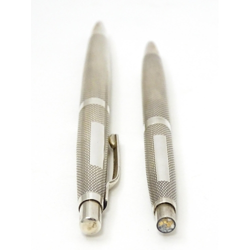 655 - Two silver pens with engine turned decoration hallmarked Birmingham 1976, maker William Manton. Larg... 