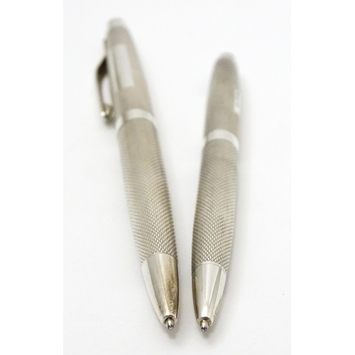 655 - Two silver pens with engine turned decoration hallmarked Birmingham 1976, maker William Manton. Larg... 