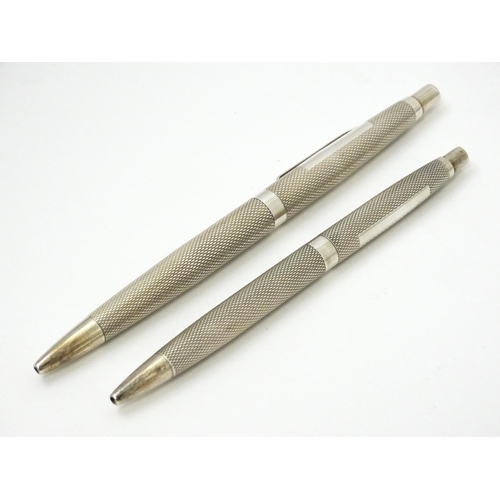 655 - Two silver pens with engine turned decoration hallmarked Birmingham 1976, maker William Manton. Larg... 