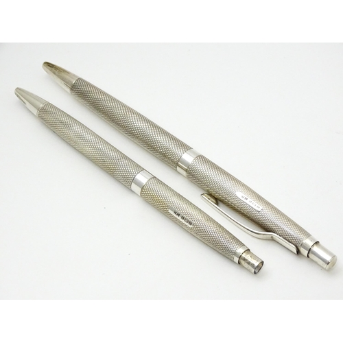 655 - Two silver pens with engine turned decoration hallmarked Birmingham 1976, maker William Manton. Larg... 