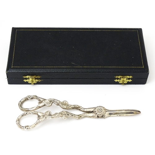 661 - Cased silver grape shears with fruiting vine decoration hallmarked London 1966, maker D. J. Silver R... 