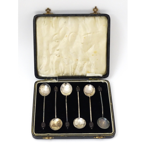 673 - A cased set of six silver coffee spoons with coffee bean finials, hallmarked Birmingham 1937, maker ... 