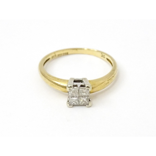 774 - A 9ct gold ring set with four diamonds in a square setting. Ring size approx. K 1/2