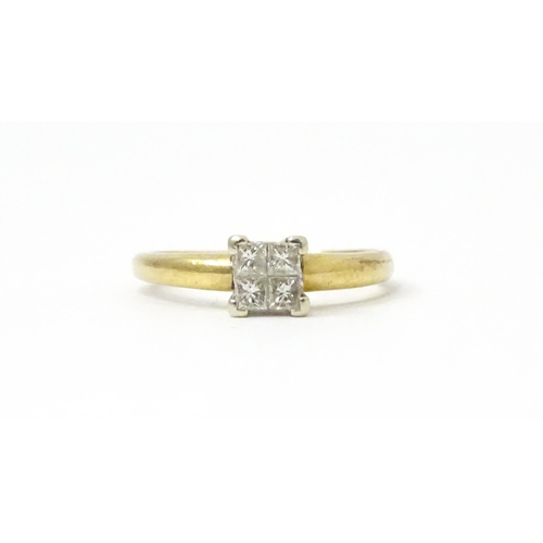 774 - A 9ct gold ring set with four diamonds in a square setting. Ring size approx. K 1/2