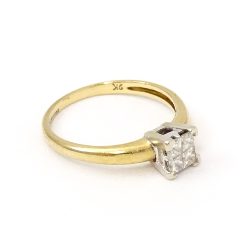 774 - A 9ct gold ring set with four diamonds in a square setting. Ring size approx. K 1/2