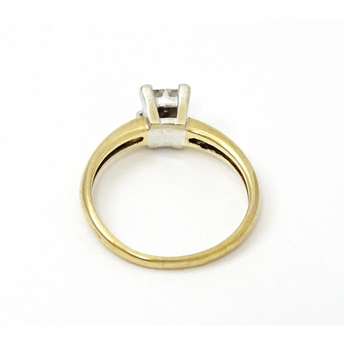 774 - A 9ct gold ring set with four diamonds in a square setting. Ring size approx. K 1/2