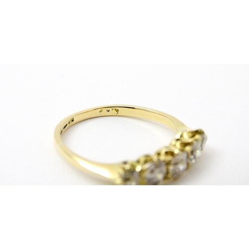 775 - An 18ct gold ring set with five old cut diamonds. Ring size approx. O