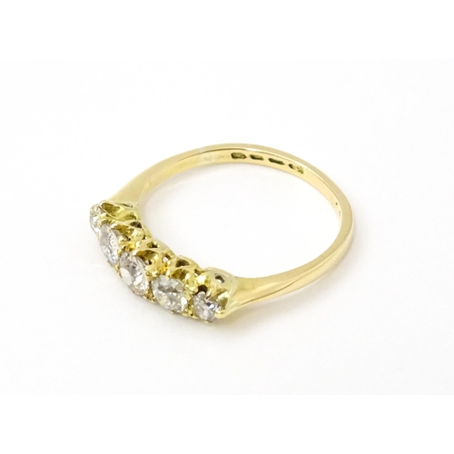 775 - An 18ct gold ring set with five old cut diamonds. Ring size approx. O