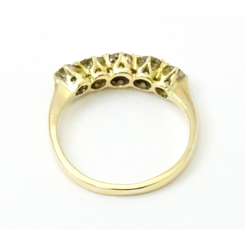 775 - An 18ct gold ring set with five old cut diamonds. Ring size approx. O