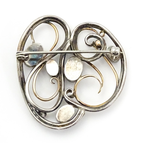 777 - A white metal brooch with yellow metal detail and set with five ruby cabochon. Approx.  1 1/2