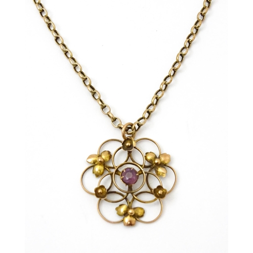 778 - An Art Nouveau 9ct gold pendant of stylised floral form set with central amethyst, with a 9ct gold c... 