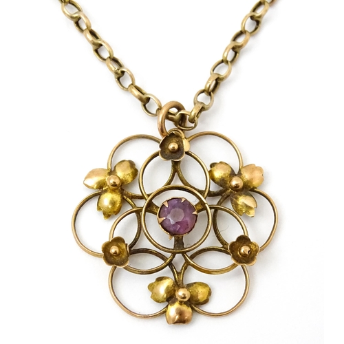 778 - An Art Nouveau 9ct gold pendant of stylised floral form set with central amethyst, with a 9ct gold c... 