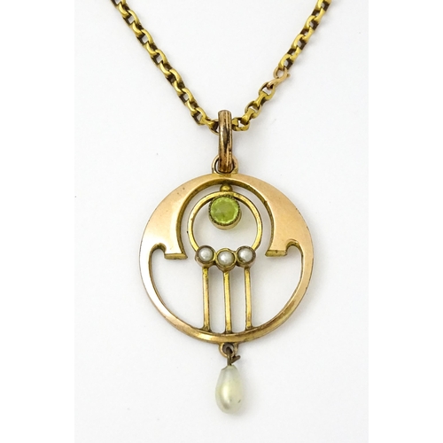 779 - An Art Nouveau yellow metal pendant set with peridot and pearl, with a yellow metal chain set with p... 