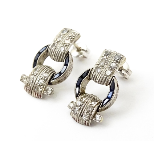 783 - A pair of Art deco style earrings set with  diamonds and sapphires. Approx 1/2