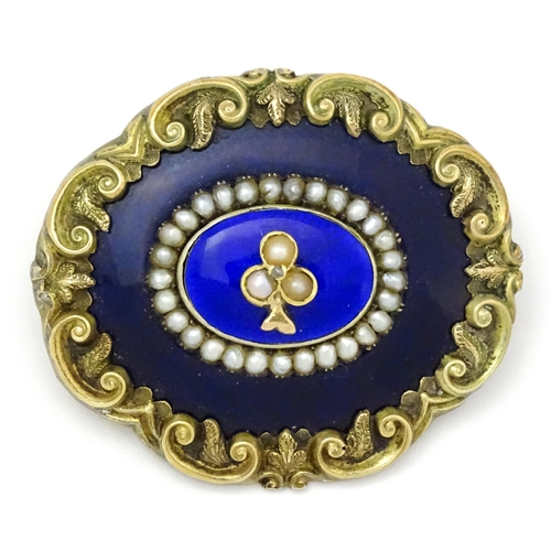 784 - A 19thC memorial / mourning brooch with blue enamel detail and central motif set with seed pearls an... 