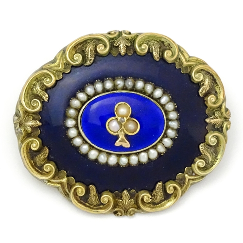 784 - A 19thC memorial / mourning brooch with blue enamel detail and central motif set with seed pearls an... 