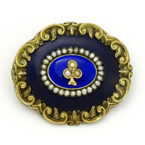 784 - A 19thC memorial / mourning brooch with blue enamel detail and central motif set with seed pearls an... 