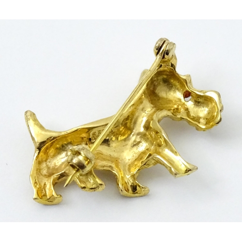 785 - A 9ct gold dog brooch formed as a Highland terrier with red stone eye. Approx 1 1/4