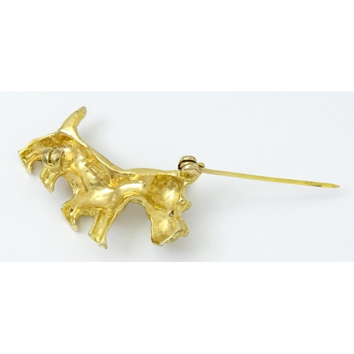 785 - A 9ct gold dog brooch formed as a Highland terrier with red stone eye. Approx 1 1/4