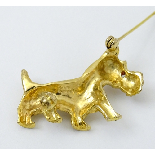 785 - A 9ct gold dog brooch formed as a Highland terrier with red stone eye. Approx 1 1/4