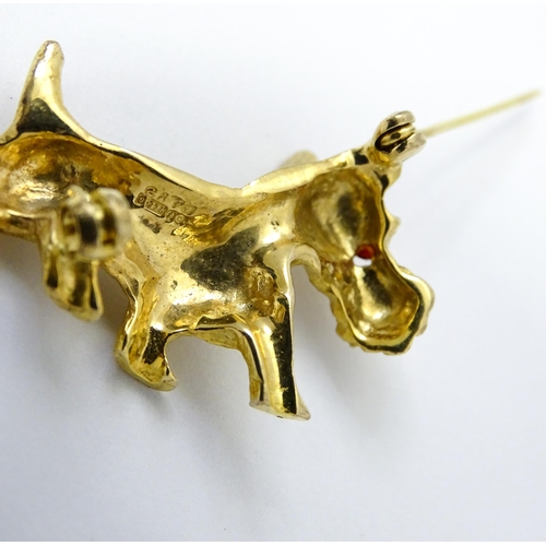 785 - A 9ct gold dog brooch formed as a Highland terrier with red stone eye. Approx 1 1/4