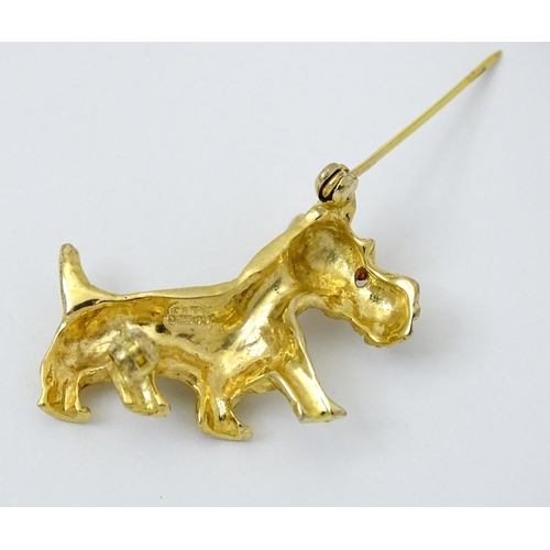 785 - A 9ct gold dog brooch formed as a Highland terrier with red stone eye. Approx 1 1/4