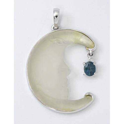 786 - A 9ct white gold Man in the Moon pendant set with optic quartz, with sapphire drop. Approx. 1 1/4