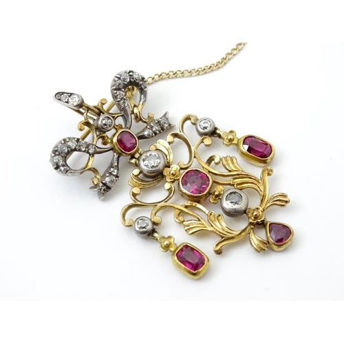 787 - A Belle Epoque pendant set with scrolling detail set with rubies and diamonds surmounted by a bow se... 