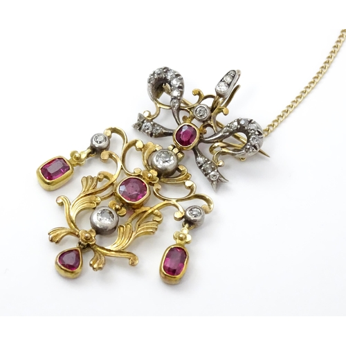 787 - A Belle Epoque pendant set with scrolling detail set with rubies and diamonds surmounted by a bow se... 