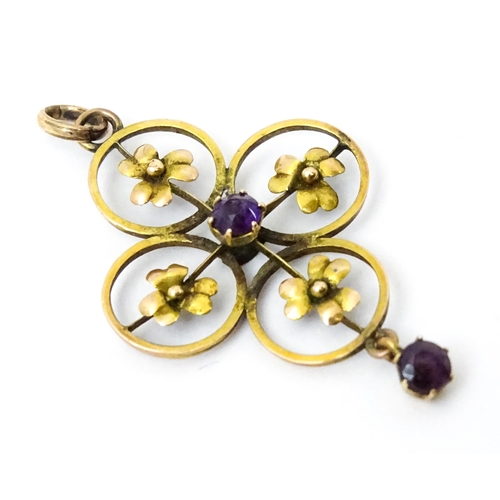 788 - A 9ct gold Art Nouveau pendant set with floral detail, amethyst to centre and amethyst drop. Approx ... 