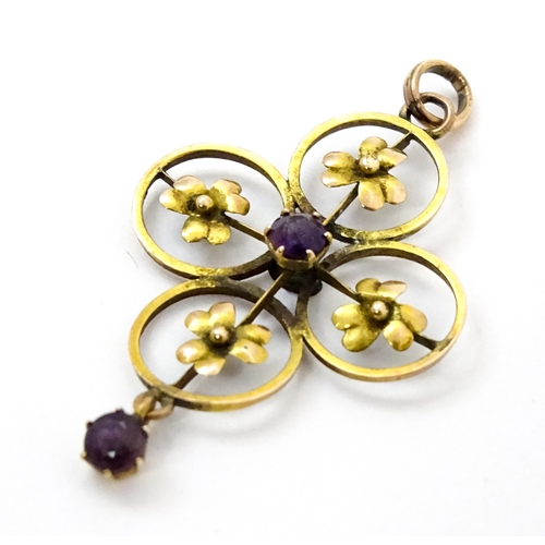 788 - A 9ct gold Art Nouveau pendant set with floral detail, amethyst to centre and amethyst drop. Approx ... 