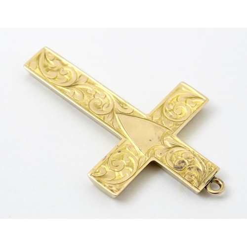 789 - A 9ct gold pendant of cross form with engraved foliate decoration hallmarked Chester 1919, maker J &... 