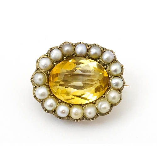 790 - A 19thC brooch set with central citrine bordered by pearls. Approx 1