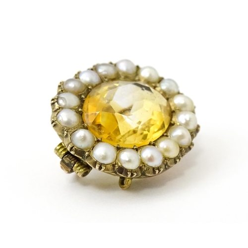 790 - A 19thC brooch set with central citrine bordered by pearls. Approx 1