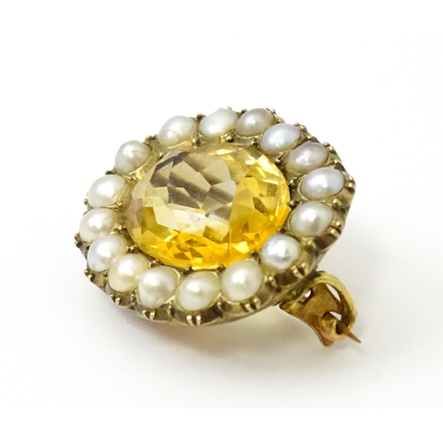 790 - A 19thC brooch set with central citrine bordered by pearls. Approx 1