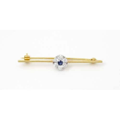 793 - A 9ct gold brooch set with central sapphire bordered by diamonds. Hallmarked London 1985 maker Slade... 