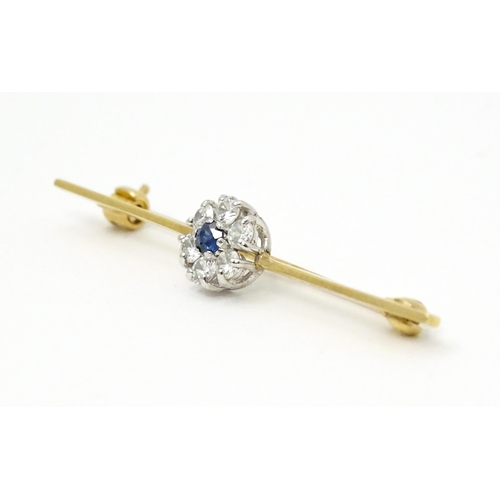 793 - A 9ct gold brooch set with central sapphire bordered by diamonds. Hallmarked London 1985 maker Slade... 