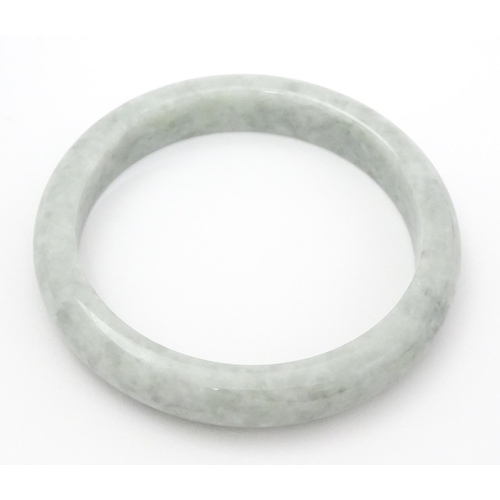 794 - A green Burmese jadeite bracelet of bangle form