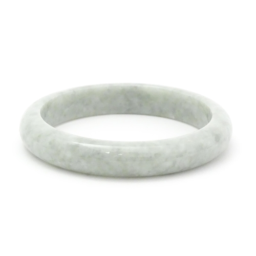 794 - A green Burmese jadeite bracelet of bangle form