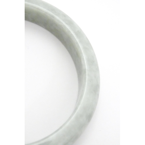 794 - A green Burmese jadeite bracelet of bangle form