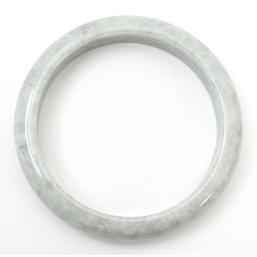 794 - A green Burmese jadeite bracelet of bangle form