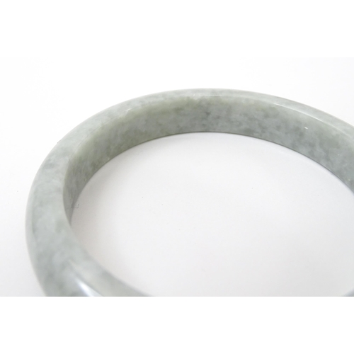 794 - A green Burmese jadeite bracelet of bangle form